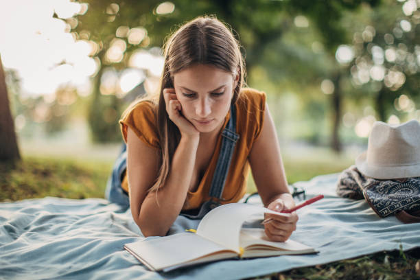 istock Woman studying in public park 1157635346