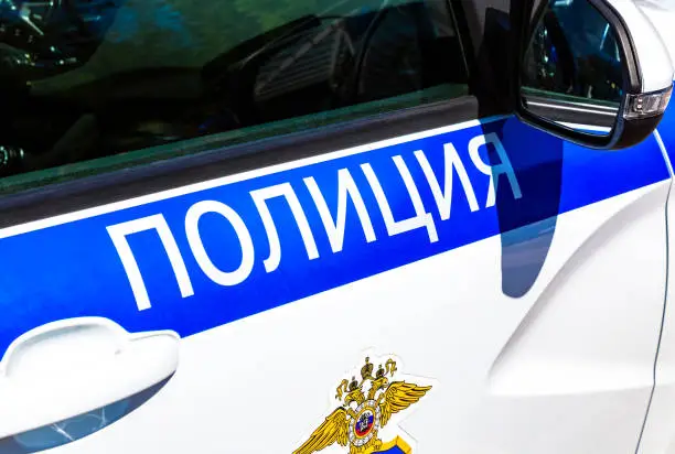 Inscription "Police" on the board of russian police vehicle. Police patrol car in Russia