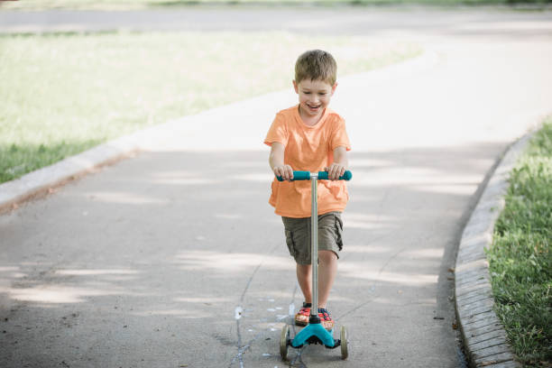 istock Little boy riding a push scooter 1157661748