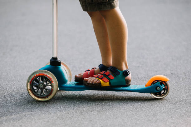 istock Little boy riding a push scooter 1157662022