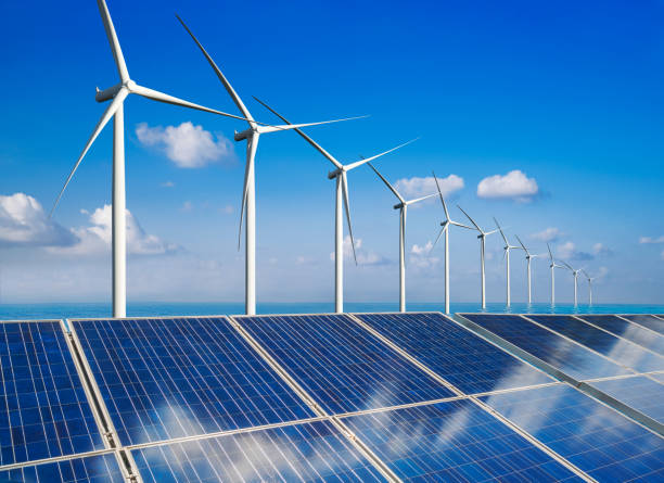 istock Solar panel and wind turbine farm clean energy. 1157670360
