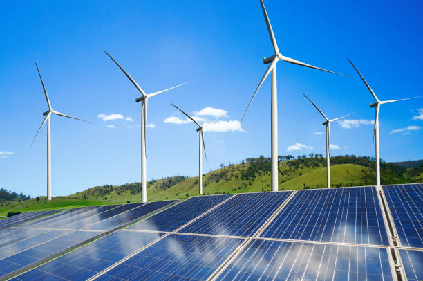 istock Solar panel and wind turbine farm clean energy. 1157670362