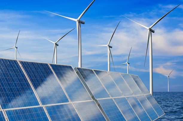 istock Solar panel and wind turbine farm clean energy. 1157670404