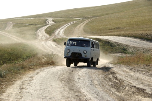 A van driving in the steppes of Mongolia, in Asia