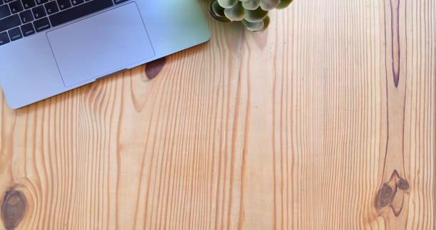 istock Laptop mock up on wood desk and copy space 1157676940