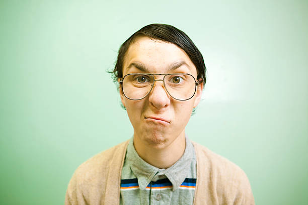 Nerdy teenager with large glasses making a face  comb over stock pictures, royalty-free photos & images