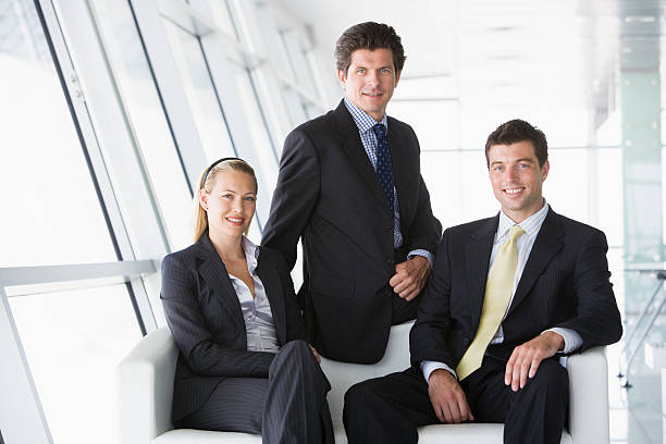 istock Three businesspeople sitting in office lobby 115768299