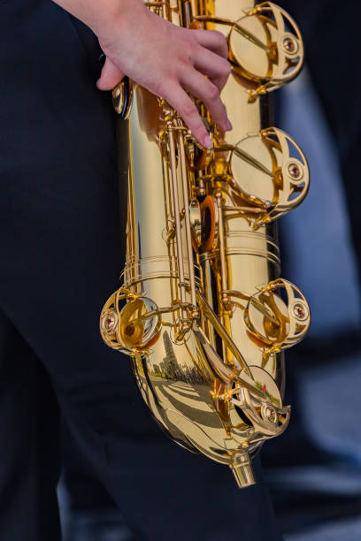 istock student playing sexaophone, music instrucment 1157683420