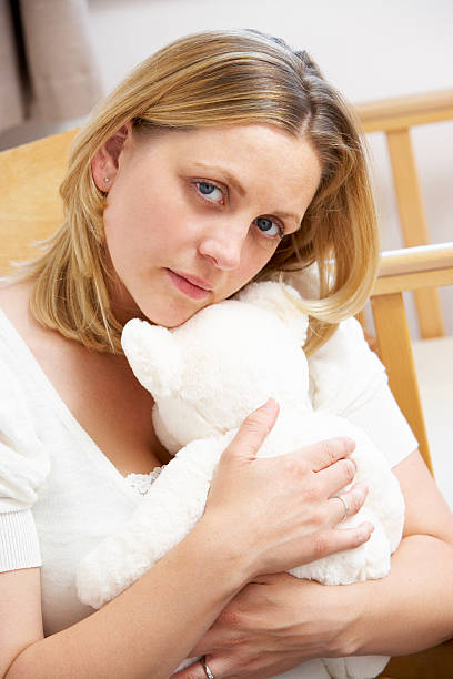 istock Sad Mother Sitting In Empty Nursery 115768349