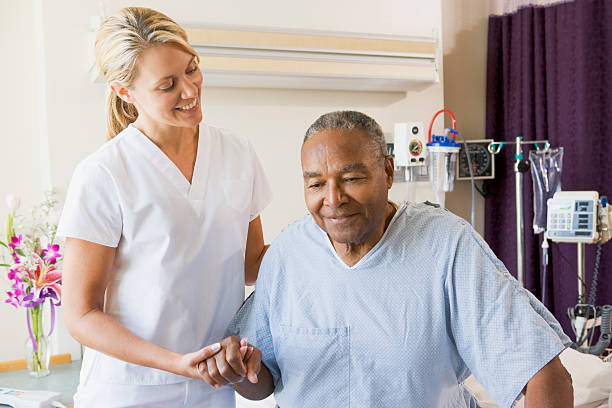 Nurse Helping Senior Man To Walk
