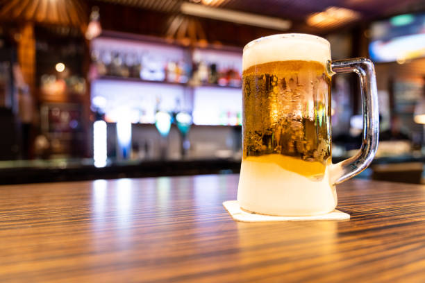 istock Pint of very cold and refreshing beer with pub background 1157684293