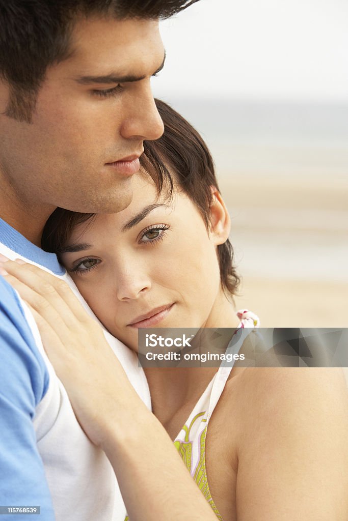 Romantic Young Couple Embracing On Beach Portrait of Romantic Young Couple Embracing On Beach Couple - Relationship Stock Photo