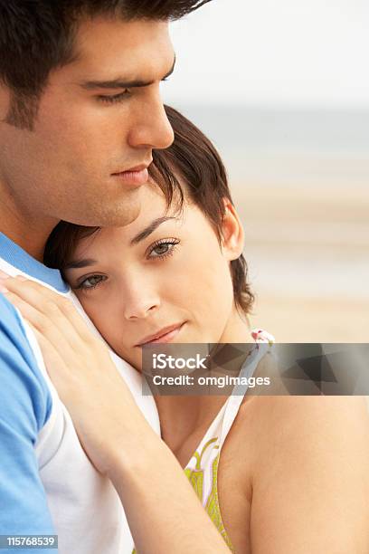 Romantic Young Couple Embracing On Beach Stock Photo - Download Image Now - Couple - Relationship, Beach, Close-up