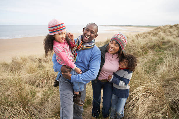 istock Family Walking Along Dunes On Beach 115768541