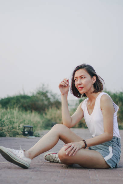 istock Women sitting on the path in the park 1157687634