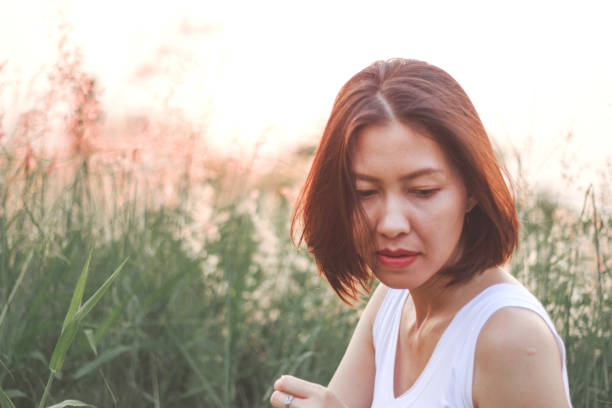 istock Woman sitting in the grass field 1157687685