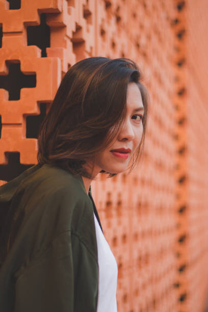 istock Women are standing against the brick wall 1157687737