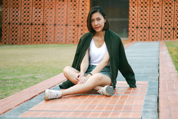 istock Woman sitting on the walkway 1157687742