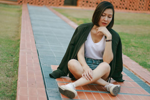 istock Woman sitting on the walkway 1157687746