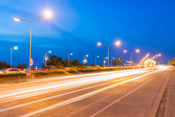 istock The light trails on the modern building background in chonburi Thailand. 1157696311