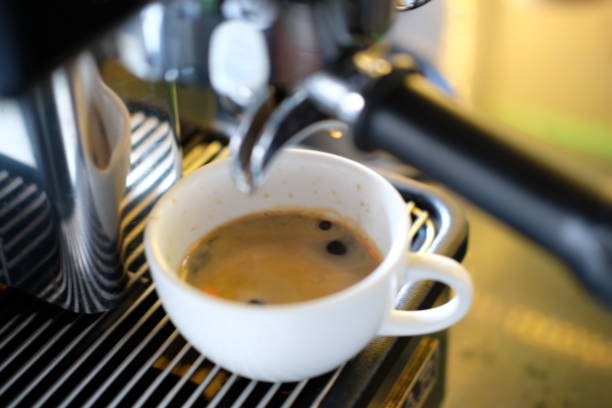 istock close up coffee cup and coffee machine 1157701560