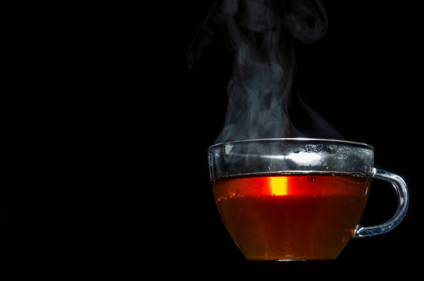 istock glass cup with tea infusion, on black background with label to write text 1157702287