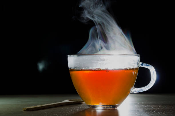 istock glass cup with tea infusion, on black background with label to write text 1157702301
