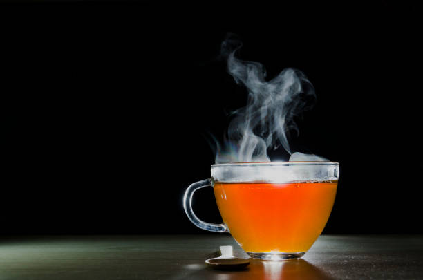istock glass cup with tea infusion, on black background with label to write text 1157702305