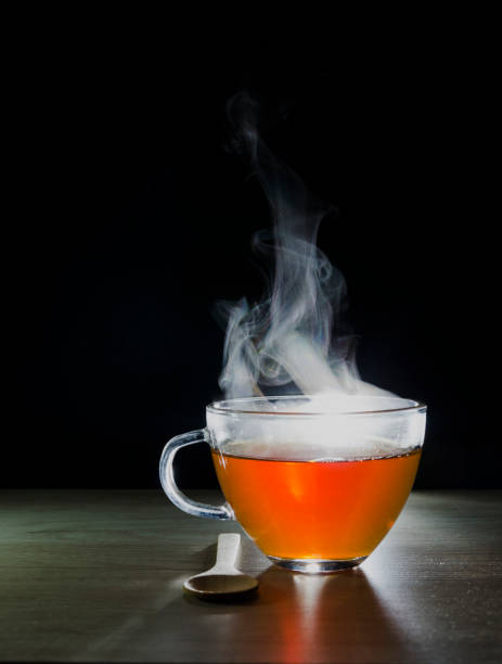 istock glass cup with tea infusion, on black background with label to write text 1157702308