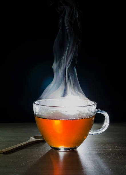 istock glass cup with tea infusion, on black background with label to write text 1157702322