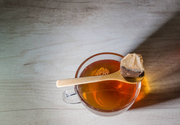 istock glass cup with tea infusion, on black background with label to write text 1157702323