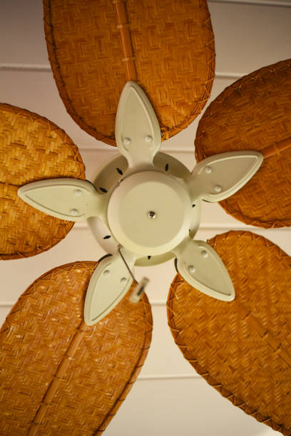 istock Close up of a ceiling fan with wicker blades. 1157702505