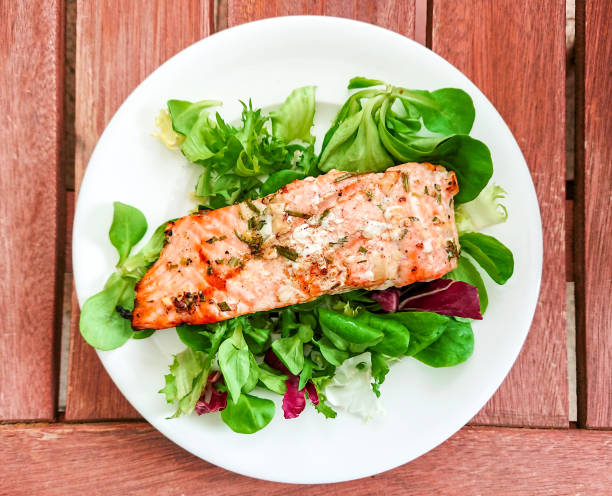 istock Grilled salmon fillet with fresh green salad 1157704033