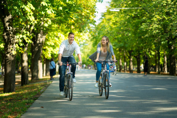 istock couple cycling in park 1157704747