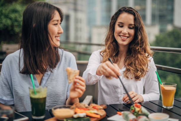 istock Two cheerful women having fun in a cafe 1157705023