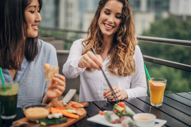 istock Two cheerful women having fun in a cafe 1157705038