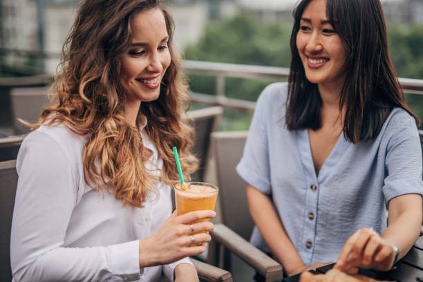 istock Two cheerful women having fun in a cafe 1157705672