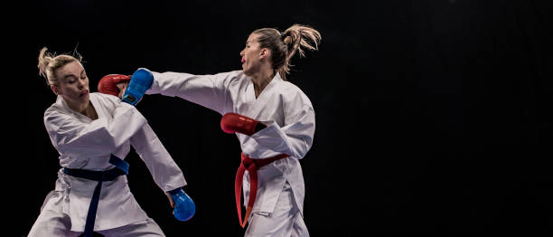 istock Female karateka punching another in the face 1157706005
