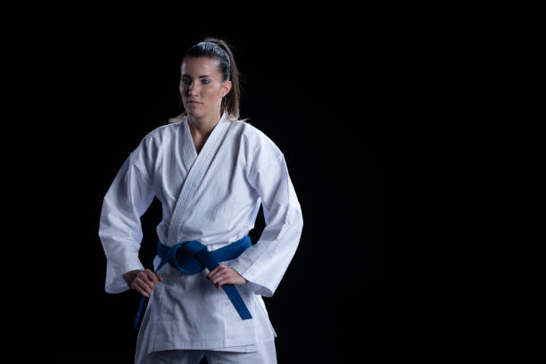 istock Female karateka tying her belt 1157706008