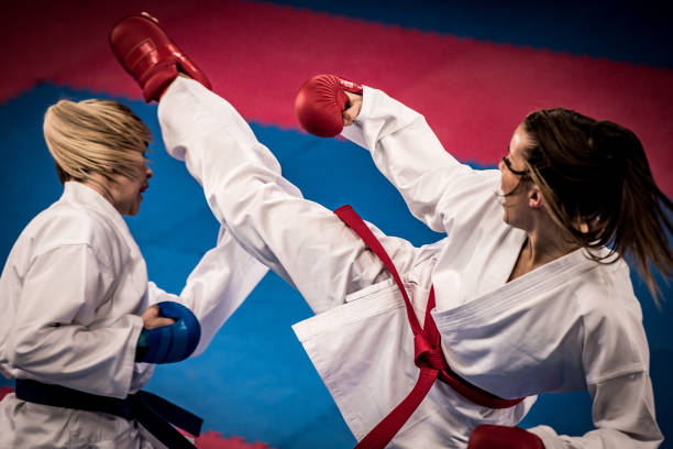 istock Close-up of female karate practitioner kicking her partner 1157706022