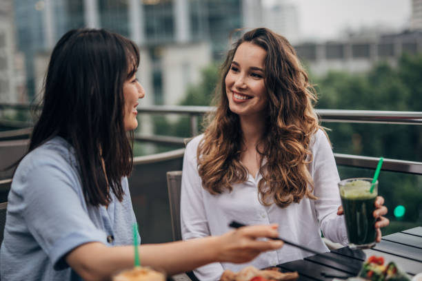 istock Two cheerful women having fun in a cafe 1157706104
