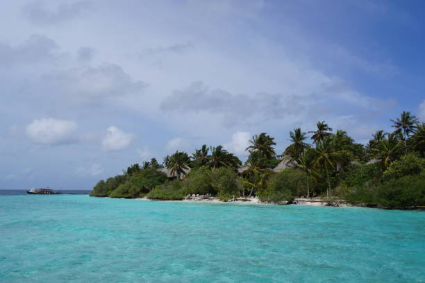 istock Cloudy sky over a tropical island resort on a sunny day 1157706112