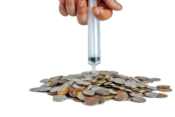 istock Men hand Injection put thai old coins into the pile on white backgrond 1157706687