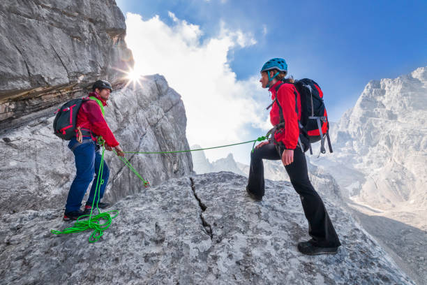 istock Mountaineer helps and secures mountaineer in Alps 1157707079