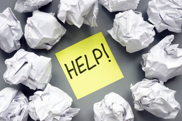 istock Sign help and paper balls around. 1157707823