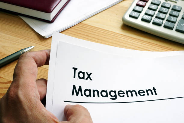 istock Man is holding Tax Management documents. 1157707836