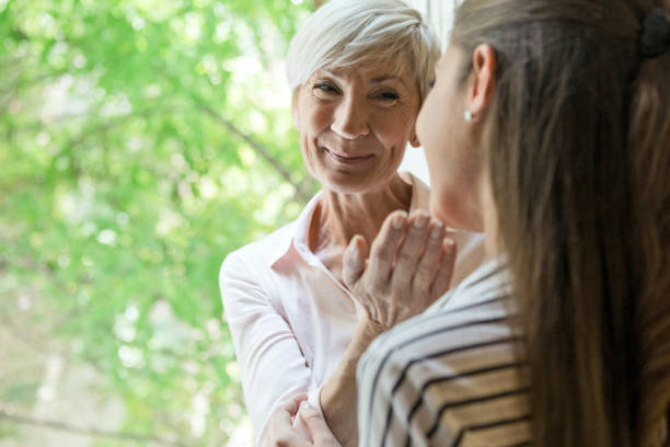 istock Mother and daughter together next to window 1157707951
