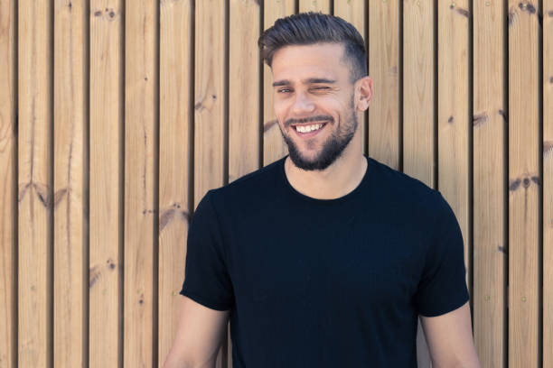 istock Smiling young man in a black T-shirt 1157708869