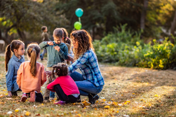 istock Group of small kids enjoying on autumn day outdoors while exploring the environment 1157711372