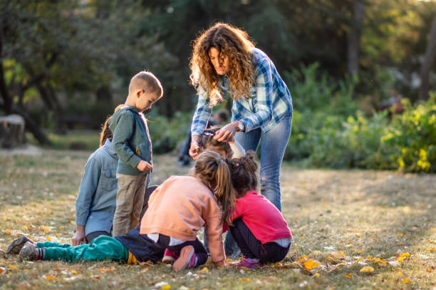 istock Group of small kids enjoying on autumn day outdoors while exploring the environment 1157711406